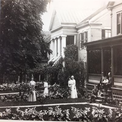 black and white photo of women in garden